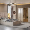 Luxurious modern bedroom with a large upholstered bed matching nightstands and a mirrored wardrobe in neutral tones