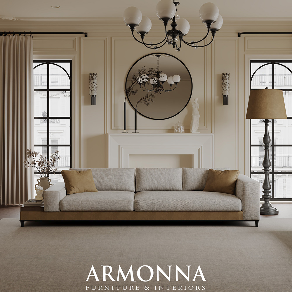 Elegant living room with a neutral beige sofa and brown pillows, classical mantel, round wall mirror, and a black chandelier.