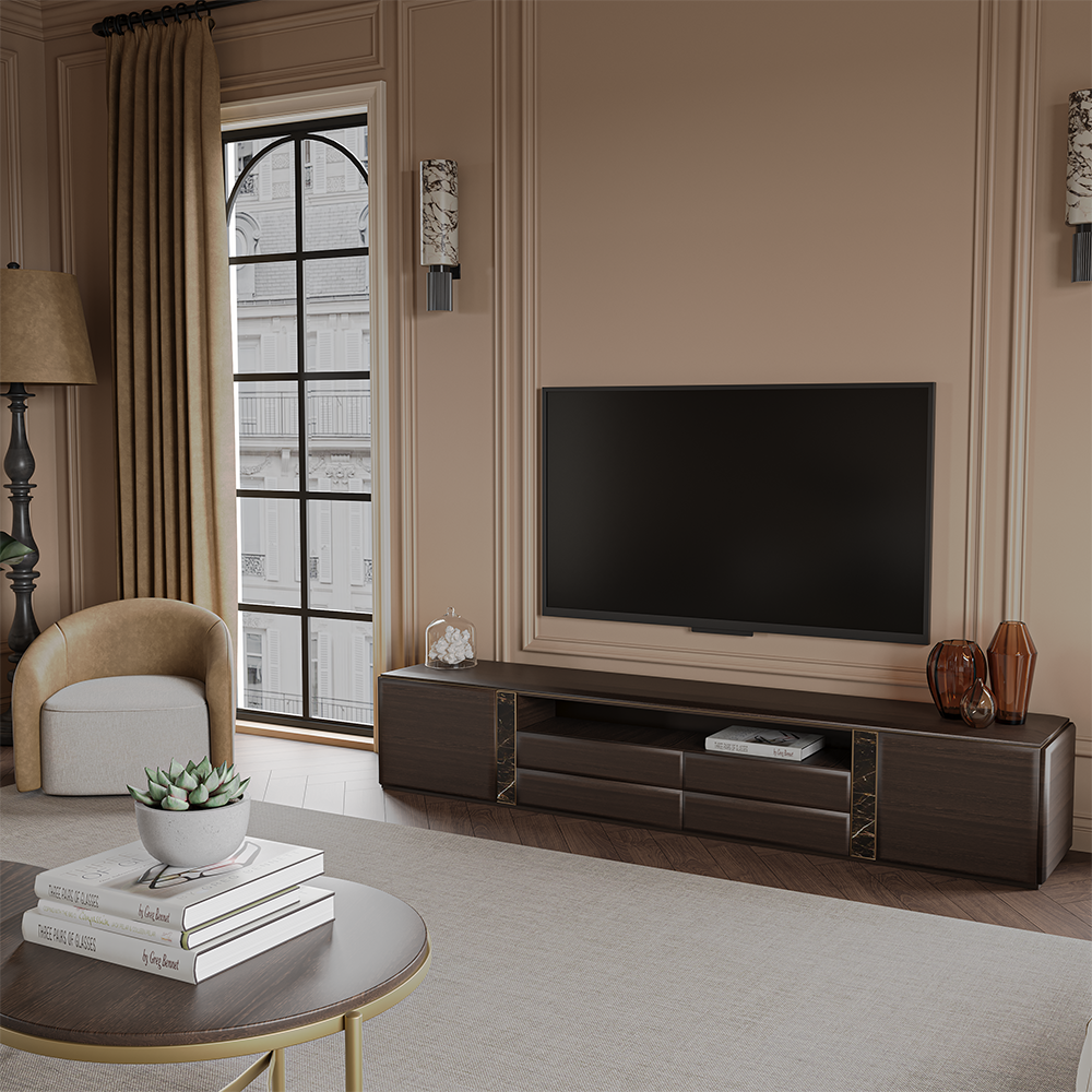 Living room with a flat-screen TV on a dark wood console, beige walls, and a round coffee table with a succulent plant and books nearby.