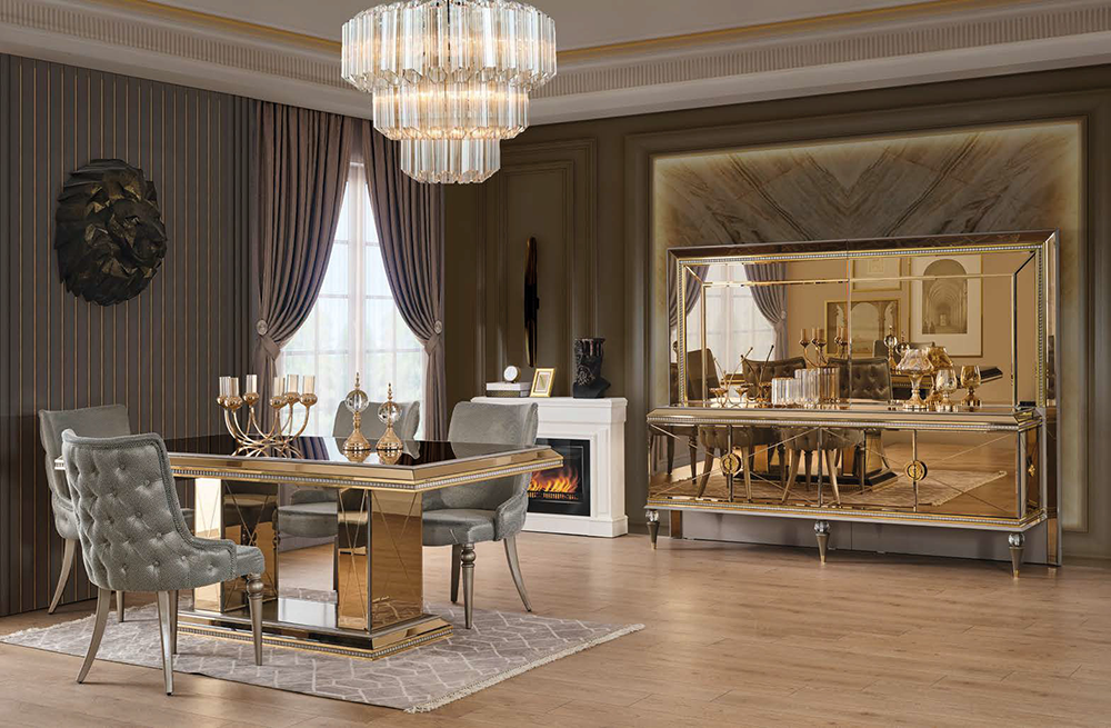 Luxurious dining room with a gold-edged glass table, four gray tufted chairs, and a crystal chandelier.
