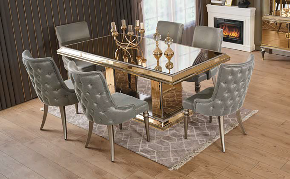 Elegant glass-top dining table with a gold frame and six tufted gray chairs in a stylish dining room.