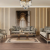 Luxurious living room with gray velvet sofa set matching chairs glass coffee table chandelier and gold accented cabinets on dark wood floors the beige rug beneath