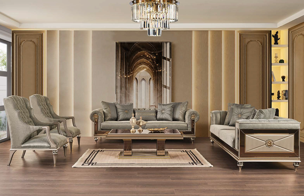 Luxurious living room with gray velvet sofa set matching chairs glass coffee table chandelier and gold accented cabinets on dark wood floors the beige rug beneath