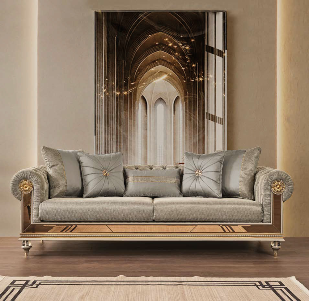 Luxurious beige gray sofa with tufted arms and decorative pillows in a sophisticated living room setting arched art piece behind it