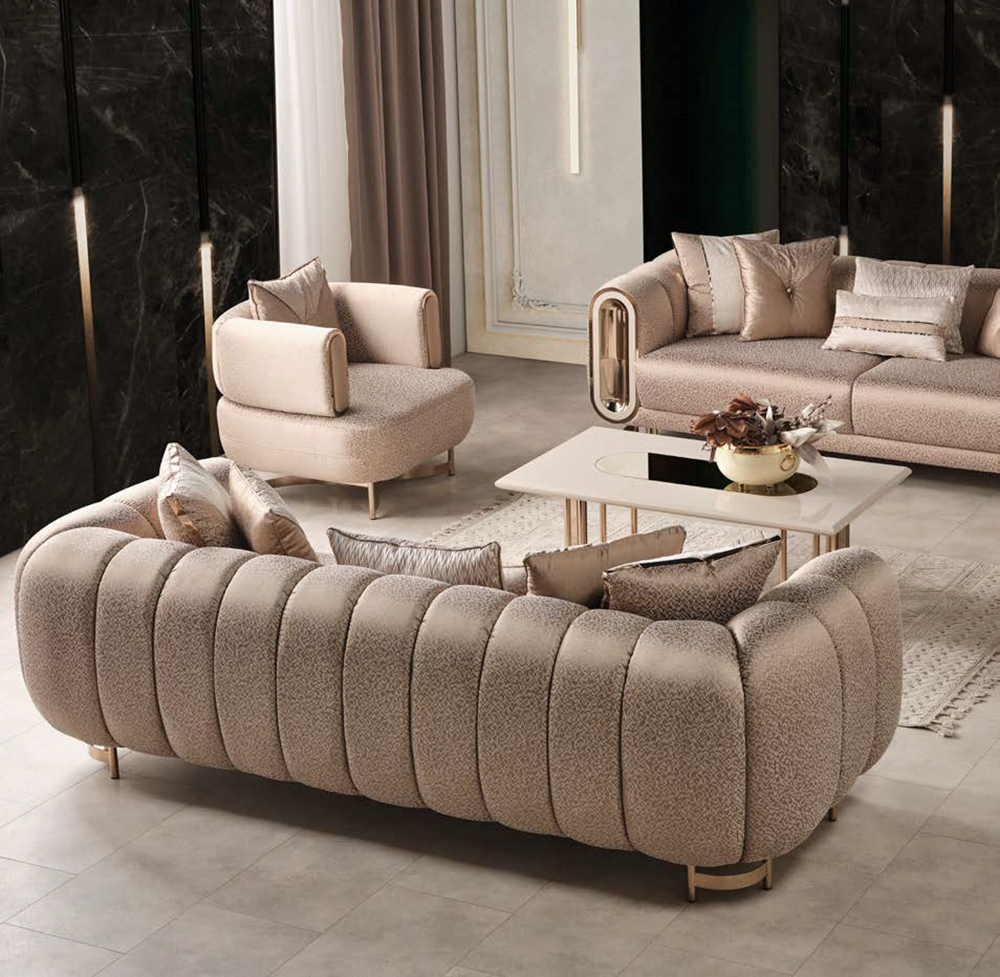 Luxurious taupe living room with plush curved boucle sofa matching armchairs and a white coffee table with gold legs and decor centerpiece