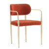 Red textured upholstered chair with a gold metal frame and slender legs armchair style