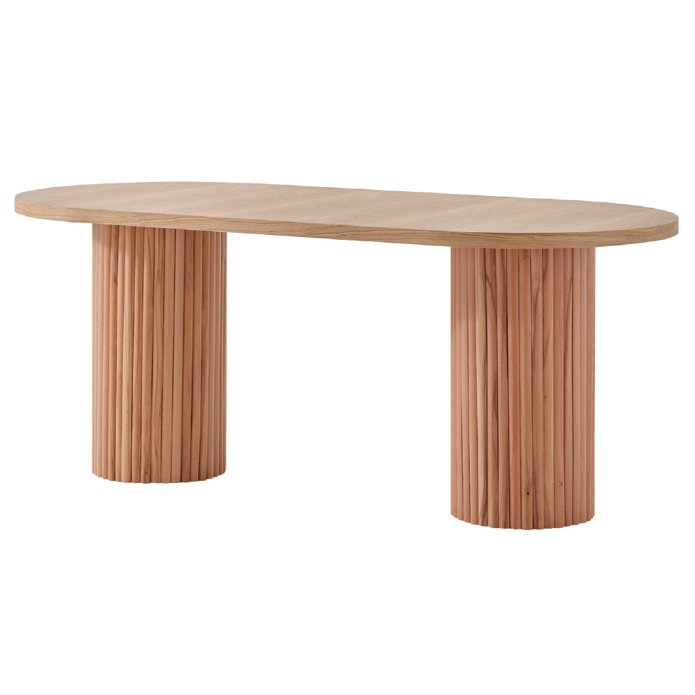 Oval wooden table with two cylindrical bases made of vertical slats, light oak finish.