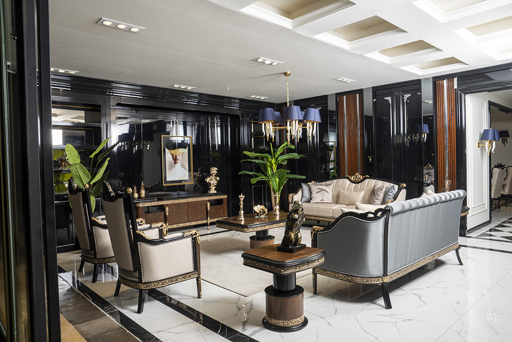 Luxurious hotel lobby with black glossy walls, white marble floor, and gold-trimmed seating.