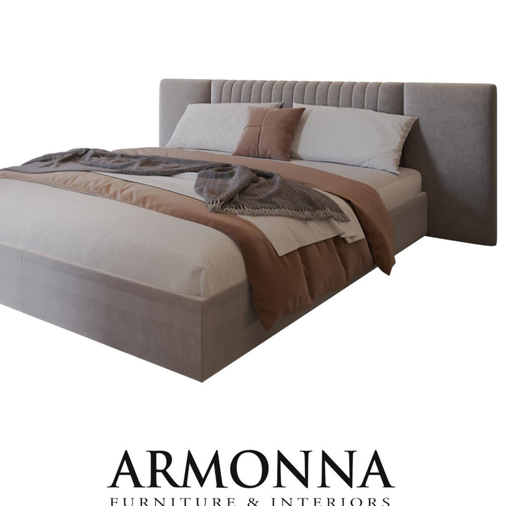 Gray upholstered bed with a tufted headboard and layered beige and brown bedding, branded ARMONNA Furniture & Interiors at the bottom of the image.