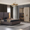 Luxurious bedroom with a king size bed upholstered headboard and matching nightstands in a dark opulent color scheme