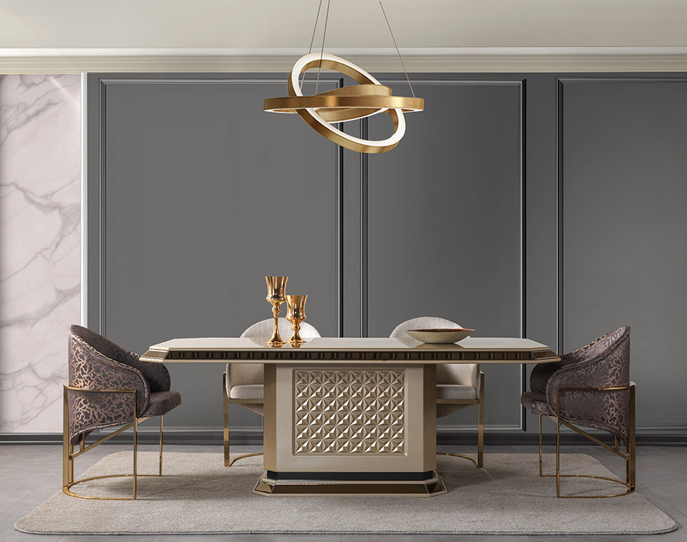 Luxurious dining room with a gold edged rectangular table diamond pattern base cream chairs and a sculptural pendant light