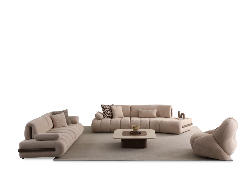 Beige modular sectional sofa set arranged around a low coffee table on a light rug, with a black background behind. In palette-neutral tones, includes multiple cushions and a curved armchair nearby.