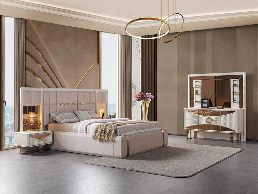 Luxurious bedroom with a plush upholstered bed, gold accents, and a white dresser with a large mirror.