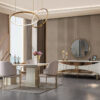 Luxurious dining room with cream and gold furniture circular pendant lights and a marble topped table