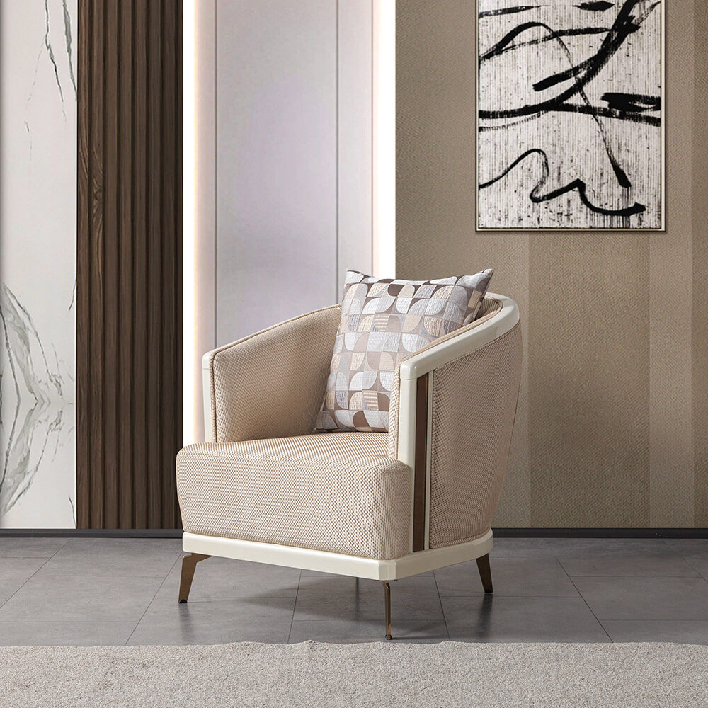 Beige upholstered armchair with a patterned throw pillow in a modern living room, beside abstract black-and-white wall art.