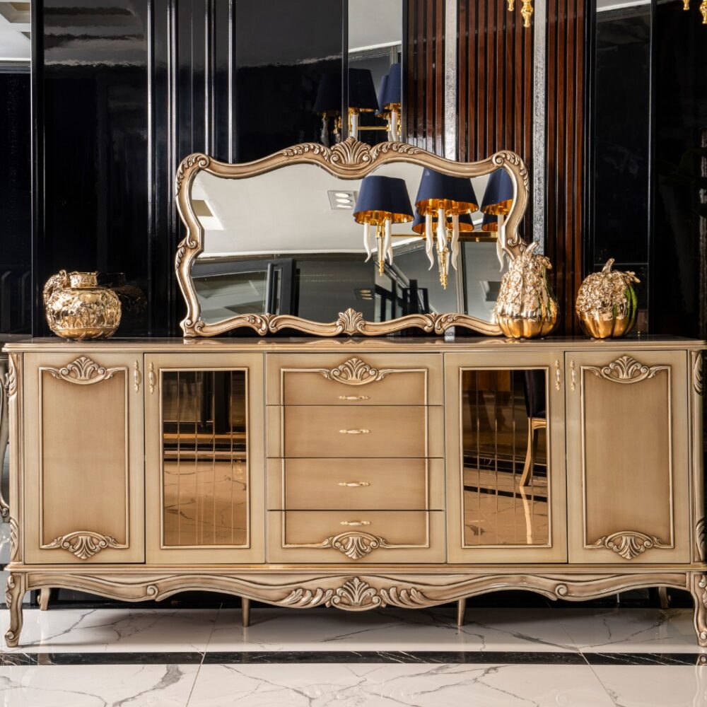 Ornate gold-toned sideboard with carved details and mirrored panels, topped by a large decorative mirror