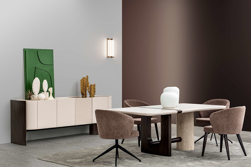 Modern dining room with a white rectangular table, six brown upholstered chairs, and a beige sideboard against gray walls with a wall light above.