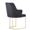 Dark blue velvet dining chair with vertical channel stitching and a gold cantilever base