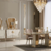 Luxurious dining room with a crystal chandelier cream furniture and a glass top table with gold accents surrounded by upholstered chairs