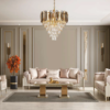 Luxurious beige living room with gold trimmed walls crystal chandelier and cream upholstered seating around a glass coffee table