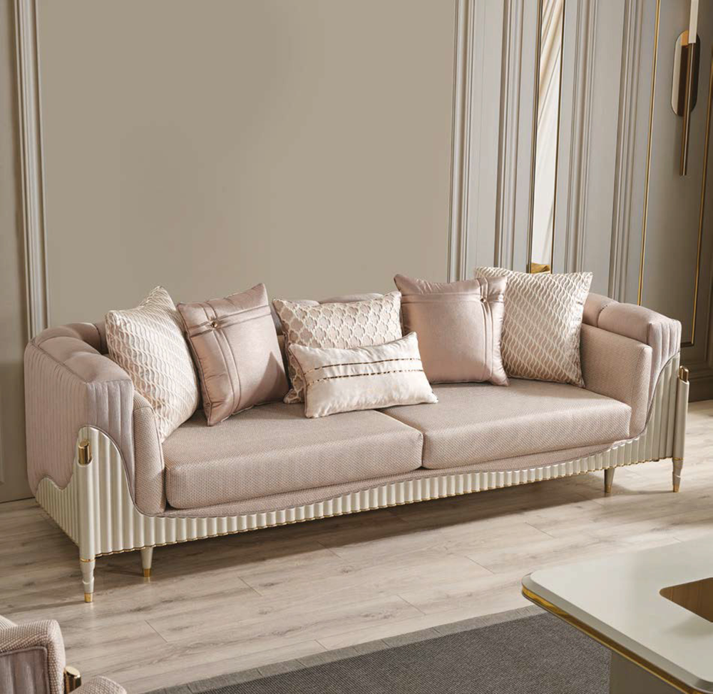 Elegant blush pink upholstered sofa with patterned and solid cushions in a modern living room setting