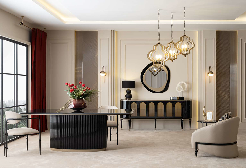Elegant living room with a glossy black curved dining table, cream chairs, a sideboard, round mirror, and gold pendant lights above.