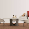 Modern dining room with a round white table on a dark curved pedestal base surrounded by four beige upholstered chairs