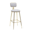 LAMA Armonna Gold tone metal bar stool with light gray upholstered seat and backrest on tall legs with a footrest
