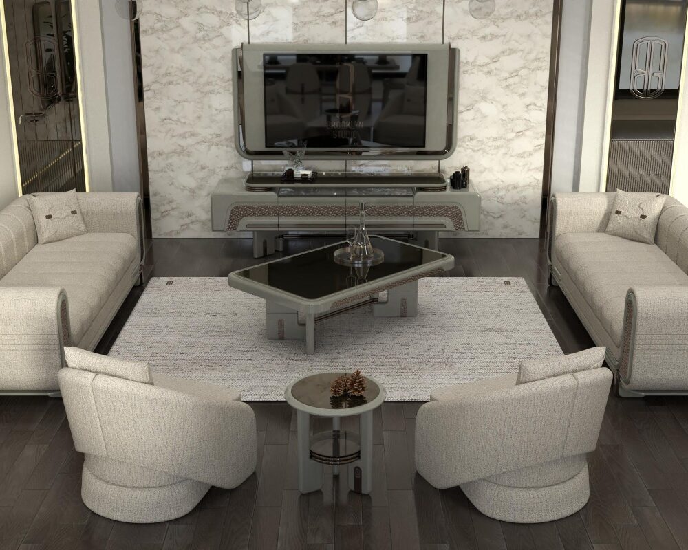 Luxurious beige living room with circular curved sofas arranged around a glass-top coffee table, marble accent wall and mounted flat-screen TV as a focal point.