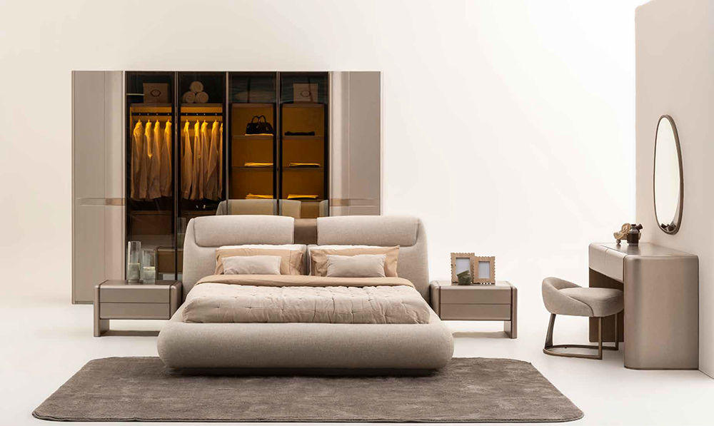 Modern bedroom with a plush low-profile bed, matching nightstands, and a large glass-front wardrobe in beige tones.