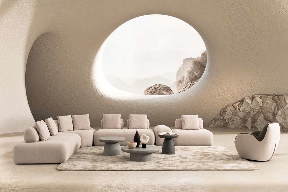 Modern lounge inside a beige cavern with a circular window showing rocky landscape; low sectional sofa, neutral rug, and round coffee tables.