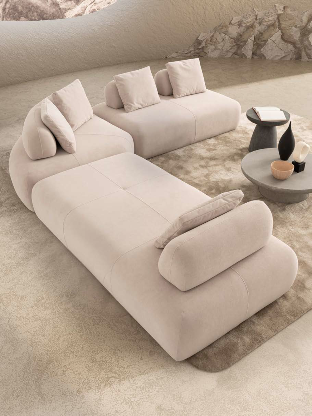 Marshmallow Corner Set3 Armonna Beige modular sofa with chaise and cushions in a neutral living room beside round coffee tables with books and decorative vases