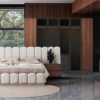 Luxurious modern bedroom with a plush beige upholstered bed circular rug wood accents and floor to ceiling windows overlooking trees