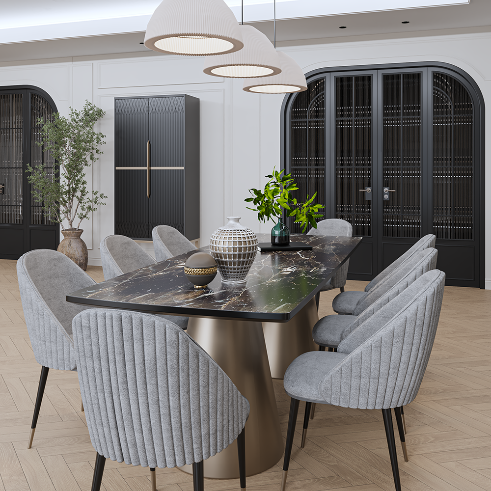 Modern dining room with a marble-topped oval table, grey ribbed chairs, a brass pedestal base, pendant lights, and black arched cabinets with plants nearby.