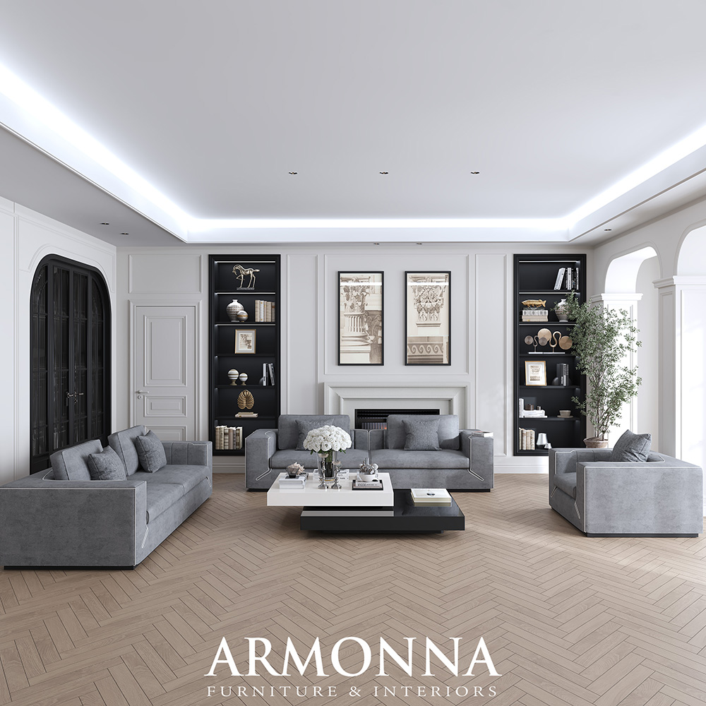 Modern living room showroom with gray sectionals, black built‑in shelves, a white fireplace, and a herringbone wood floor.