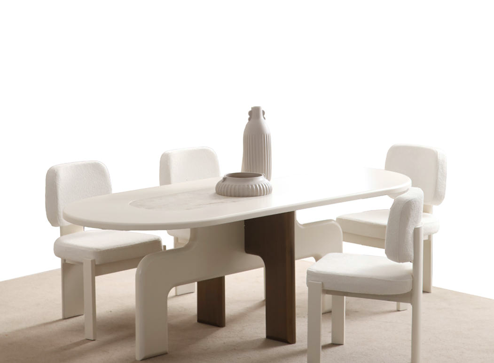White oval dining table with six white upholstered chairs; a tall vase and round centerpiece on the table.