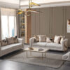 Modern living room with two cream sofas a matching armchair gold metal frames and a rectangular coffee table on a light gray rug in a neutral scheme