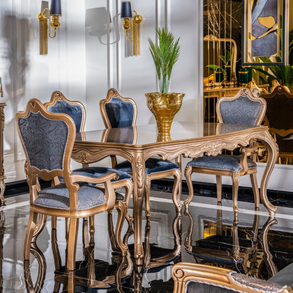 Luxurious gold-painted dining set with blue velvet chairs around a mirrored table, marble floor.