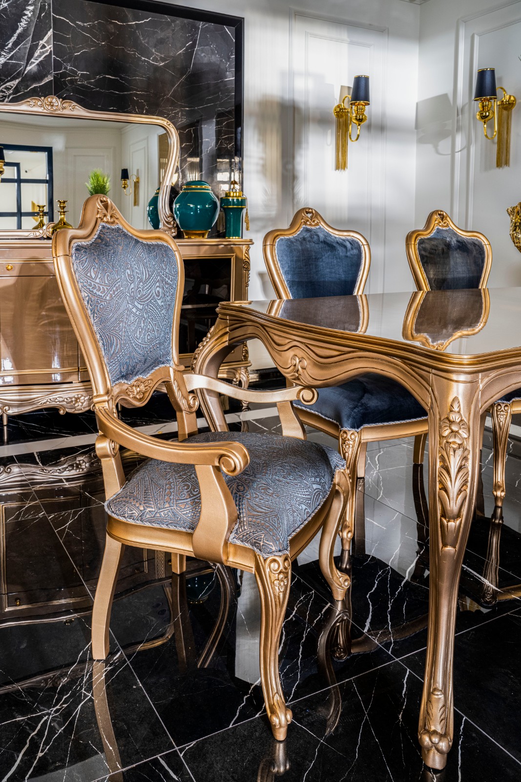 Napoli Classic Set 17 Armonna Luxurious dining room with gold framed blue upholstered chairs around a glass topped ornate table on a black marble floor