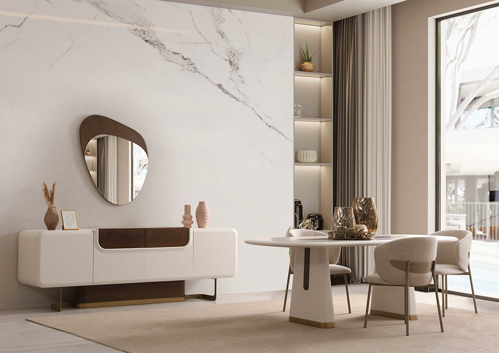 Modern living and dining area with a white and wood sideboard, marble wall, and a round mirror above.