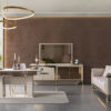 Luxurious modern dining and living room with a glass dining table pale chairs gold accents and a velvet brown feature wall behind a TV console and sofa set