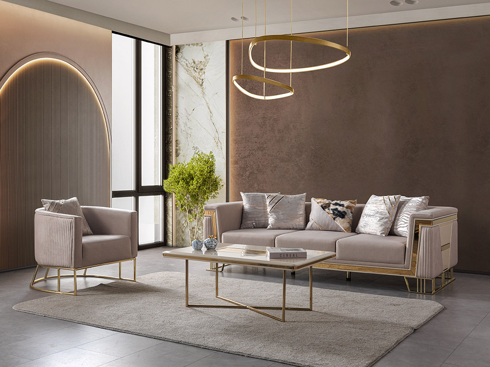 Nisan Living Room 12 Armonna Contemporary living room with blush beige sofa and matching armchair gold metal frames a rectangular coffee table and circular pendant lights in a luxe setting