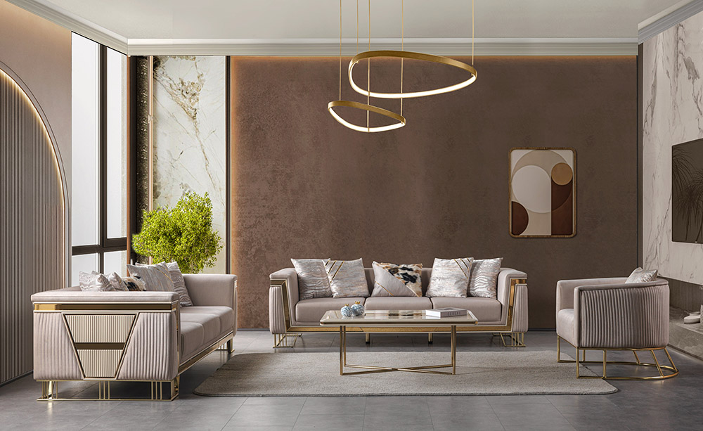 Luxurious contemporary living room with pink velvet sofas and chairs gold metal frames a glass coffee table and a textured brown feature wall under circular gold pendant lights