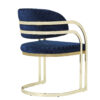 Blue upholstered armchair with a gold metal frame and rounded base modern design