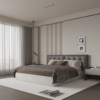 Modern hotel style bedroom with a tufted grey headboard brown bedding and a white rug large window with sheer curtains on the left nightstand with a book and mug on the right