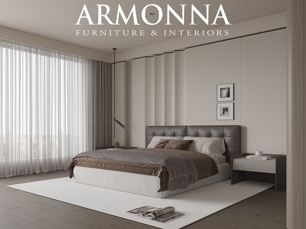 Modern bedroom interior with a tufted gray headboard bed, neutral linens, and sheer curtains by large windows.