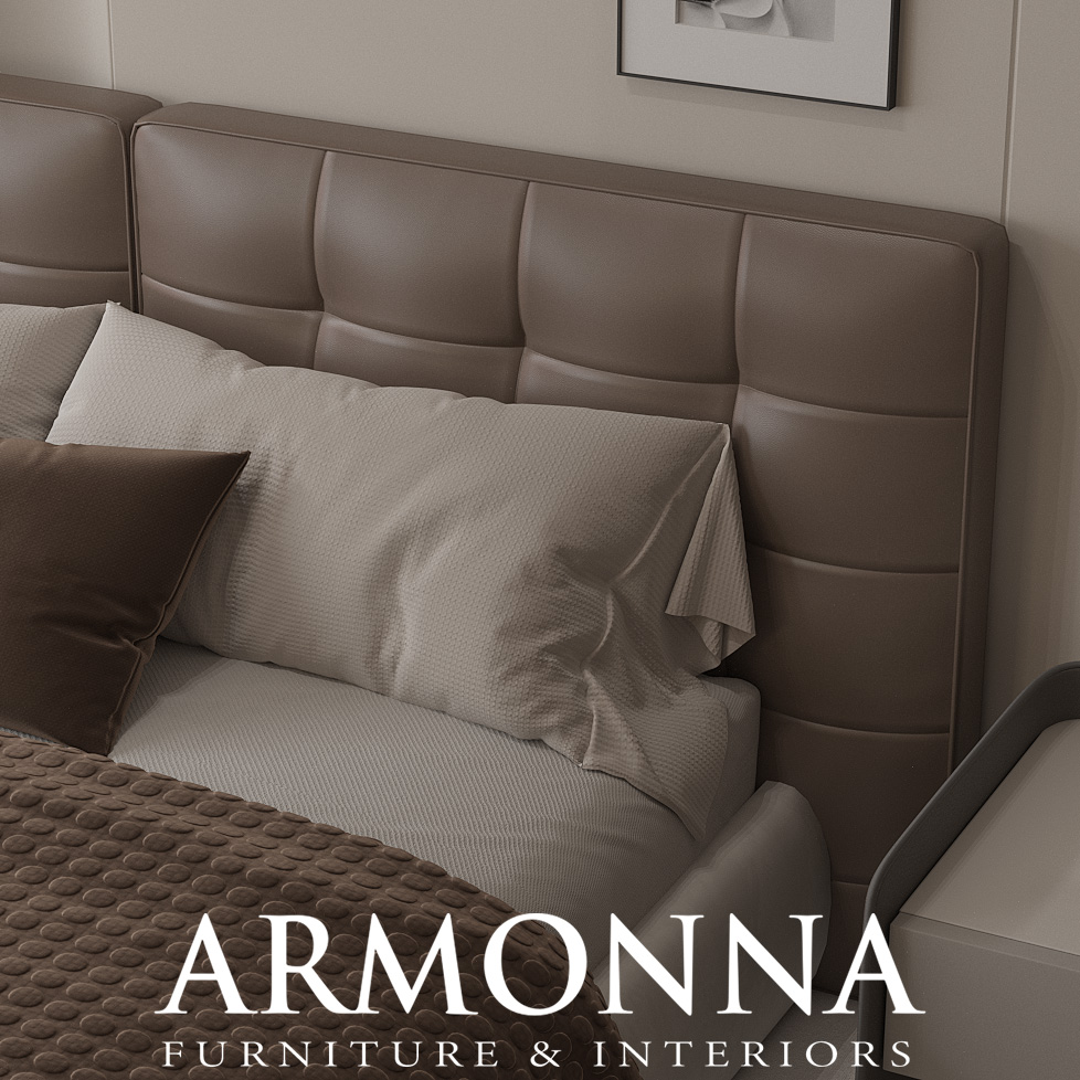 Neutral-toned bedroom with a brown, tufted headboard, white bedding, and pillows; ARMONNA Furniture & Interiors logo at the bottom