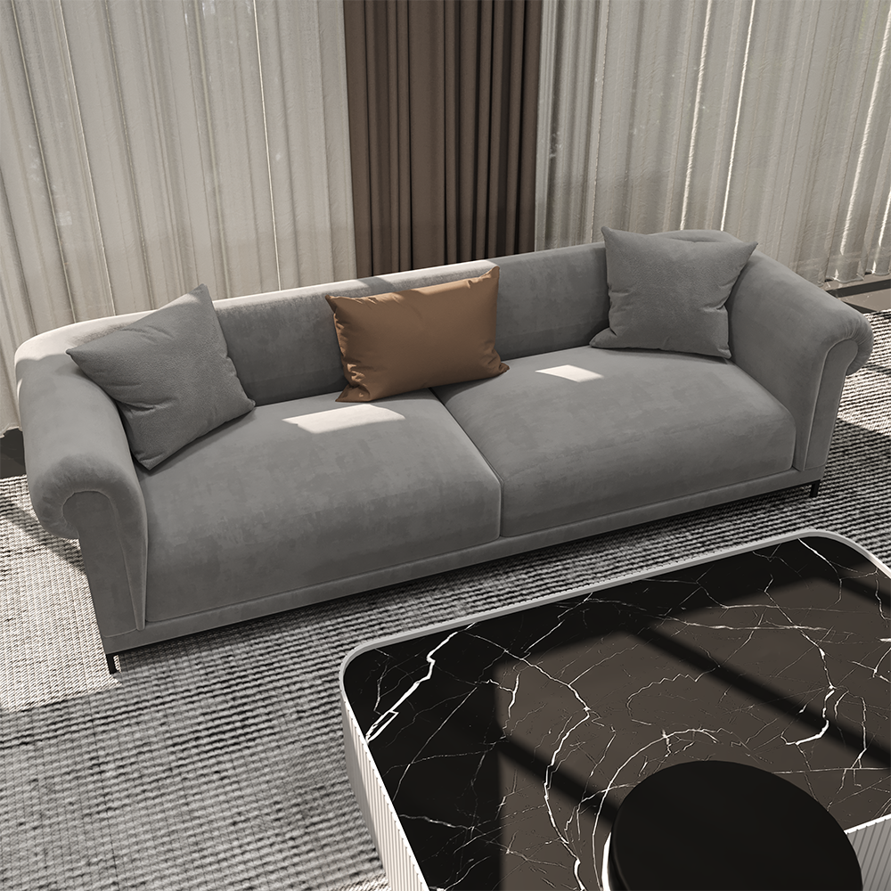 Gray sofa with two gray cushions and a brown accent pillow in a modern living room, next to a black marble coffee table.
