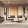 Modern living room with beige sofas brown leather accents round coffee tables and a tall bookshelf framing the space on a light rug windowed wall