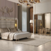 Luxurious modern bedroom with a padded upholstered bed mirrored wardrobe and soft beige decor
